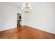 Classic dining room features hardwood flooring, wainscoting, and a modern chandelier at 1801 Summerview Ct, Woodstock, GA 30189