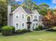 Two-story traditional home boasts mature landscaping, manicured lawn, and an inviting facade at 1801 Summerview Ct, Woodstock, GA 30189