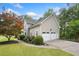 A two-story home displays a 3-car garage, meticulous landscaping, and a paved walkway at 1801 Summerview Ct, Woodstock, GA 30189