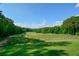 Golf course driving range with golfers and beautiful green landscape at 1801 Summerview Ct, Woodstock, GA 30189