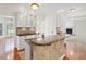 Open kitchen featuring white cabinets, granite countertops, tile-covered island, and hardwood floors at 1801 Summerview Ct, Woodstock, GA 30189