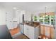 Bright kitchen features granite countertops, stainless steel appliances, and hardwood floors at 1801 Summerview Ct, Woodstock, GA 30189