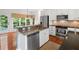 Eat-in kitchen offers stainless appliances, island with granite countertop, and views to the yard at 1801 Summerview Ct, Woodstock, GA 30189