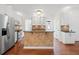 Well-lit kitchen with white cabinets, granite countertops, stainless steel appliances and tile-covered island at 1801 Summerview Ct, Woodstock, GA 30189
