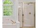 Main bathroom with a jetted tub, glass shower and window with blinds at 1801 Summerview Ct, Woodstock, GA 30189