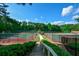 Picturesque view of tennis courts, gazebo, and greenery, enhancing community appeal at 1801 Summerview Ct, Woodstock, GA 30189