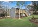 Back exterior featuring a wooden deck with stairs and a grassy yard, ideal for outdoor entertaining and relaxation at 3414 Dearwood Sw Dr, Lilburn, GA 30047