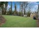 Large grassy backyard with a shed, deck, and mature trees creating an expansive outdoor living space at 3414 Dearwood Sw Dr, Lilburn, GA 30047