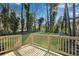 Newly constructed backyard deck featuring wood flooring and railings overlooking the grassy yard and mature trees at 3414 Dearwood Sw Dr, Lilburn, GA 30047