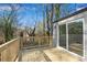 Backyard deck with wood railings, wood flooring, and sliding glass door providing an outdoor living space at 3414 Dearwood Sw Dr, Lilburn, GA 30047
