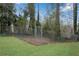 Fenced-in backyard with a metal gate, providing a secure area for outdoor activities and enjoyment at 3414 Dearwood Sw Dr, Lilburn, GA 30047
