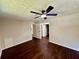 Basement bedroom with wood-look flooring, a ceiling fan, and access to other rooms at 3414 Dearwood Sw Dr, Lilburn, GA 30047