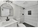 Modern bathroom featuring a new vanity, shower with decorative niche, and updated fixtures at 3414 Dearwood Sw Dr, Lilburn, GA 30047