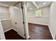 Bedroom featuring wood-look flooring, a closet, and a window with natural light at 3414 Dearwood Sw Dr, Lilburn, GA 30047