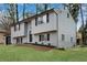 Beautiful gray home with black shutters, a one car garage, and manicured landscaping at 3414 Dearwood Sw Dr, Lilburn, GA 30047