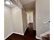 Hallway with wood floors, neutral walls, and a view into another room with natural light at 3414 Dearwood Sw Dr, Lilburn, GA 30047