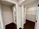 Hallway featuring access to a bathroom and closet with ample shelving and fresh paint at 3414 Dearwood Sw Dr, Lilburn, GA 30047