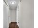 Bright hallway featuring wood floors, neutral paint, closet doors and access to other rooms at 3414 Dearwood Sw Dr, Lilburn, GA 30047