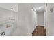 Hallway features new wood floors, fresh gray paint, and a modern light fixture near the front door at 3414 Dearwood Sw Dr, Lilburn, GA 30047