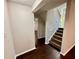 Hallway with wood flooring and a staircase, leading to other areas of the home at 3414 Dearwood Sw Dr, Lilburn, GA 30047