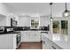 Kitchen featuring stainless appliances, white cabinets, an island, and black subway tile backsplash at 3414 Dearwood Sw Dr, Lilburn, GA 30047