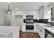 Bright kitchen featuring stainless appliances, white cabinets, subway tile backsplash, and a large island at 3414 Dearwood Sw Dr, Lilburn, GA 30047