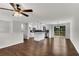 Bright open floor plan featuring wood floors, white kitchen with island, stainless appliances, and sliding door to deck at 3414 Dearwood Sw Dr, Lilburn, GA 30047