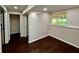 View of room with wood-look floors and a window, with access to rooms with closets at 3414 Dearwood Sw Dr, Lilburn, GA 30047