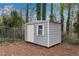 Exterior view of backyard storage shed featuring a window, door, and corrugated metal paneling at 3414 Dearwood Sw Dr, Lilburn, GA 30047