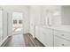 Bright bathroom featuring a double sink vanity, modern fixtures, and sleek wood-look floors at 41 Bandimere Parkway, Dallas, GA 30157