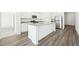 Modern kitchen with white cabinets, stainless steel appliances, and a large granite island at 41 Bandimere Parkway, Dallas, GA 30157
