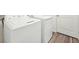 Close-up of a white washing machine and dryer set against a white wall with wood floors at 41 Bandimere Parkway, Dallas, GA 30157