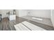 Bright living room with hardwood floors flowing to carpet and a view of the kitchen at 41 Bandimere Parkway, Dallas, GA 30157