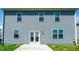 Exterior view of the back of the home, showcasing windows and a concrete patio at 4420 Merrigold Way, Fairburn, GA 30213