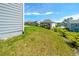 View of the grassy backyard featuring a wooden fence at 4420 Merrigold Way, Fairburn, GA 30213