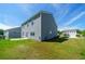 Backyard view of the home, showing the rear facade, concrete patio, and green space at 4420 Merrigold Way, Fairburn, GA 30213