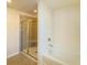 A bright bathroom featuring a walk-in shower and a tub at 4420 Merrigold Way, Fairburn, GA 30213