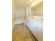 Bright bathroom featuring a double sink vanity, large mirror and shower-tub combination at 4420 Merrigold Way, Fairburn, GA 30213