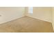 A bright bedroom with neutral walls and carpeting at 4420 Merrigold Way, Fairburn, GA 30213