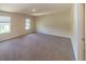 A bright bedroom with neutral carpet and two windows at 4420 Merrigold Way, Fairburn, GA 30213