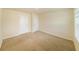 Bedroom with neutral walls, carpet flooring, and a window offering natural light at 4420 Merrigold Way, Fairburn, GA 30213