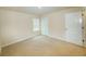 This bedroom features neutral walls, plush carpeting, and a window providing natural light at 4420 Merrigold Way, Fairburn, GA 30213