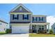 Charming two-story home featuring a two-car garage and classic curb appeal at 4420 Merrigold Way, Fairburn, GA 30213