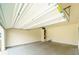 Spacious garage with a high ceiling, showcasing ample room for vehicles and storage at 4420 Merrigold Way, Fairburn, GA 30213