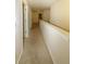 Spacious hallway with neutral walls and carpet flooring leads to different rooms at 4420 Merrigold Way, Fairburn, GA 30213