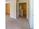 An interior hallway with neutral carpeting and doorways at 4420 Merrigold Way, Fairburn, GA 30213