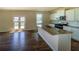 Spacious kitchen with granite countertops, stainless appliances, and white cabinets, seamlessly connected to the living area at 4420 Merrigold Way, Fairburn, GA 30213