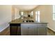 The kitchen features granite countertops, an island with a sink, stainless appliances, and an open living space at 4420 Merrigold Way, Fairburn, GA 30213
