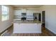 Bright kitchen features a center island, granite countertops, stainless steel appliances, and hardwood floors at 4420 Merrigold Way, Fairburn, GA 30213