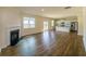 Spacious living area features hardwood floors, a fireplace, and an open kitchen with stainless steel appliances at 4420 Merrigold Way, Fairburn, GA 30213